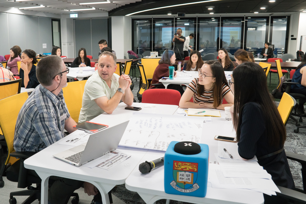 Participants collaborating around a table at a CiC Workshop